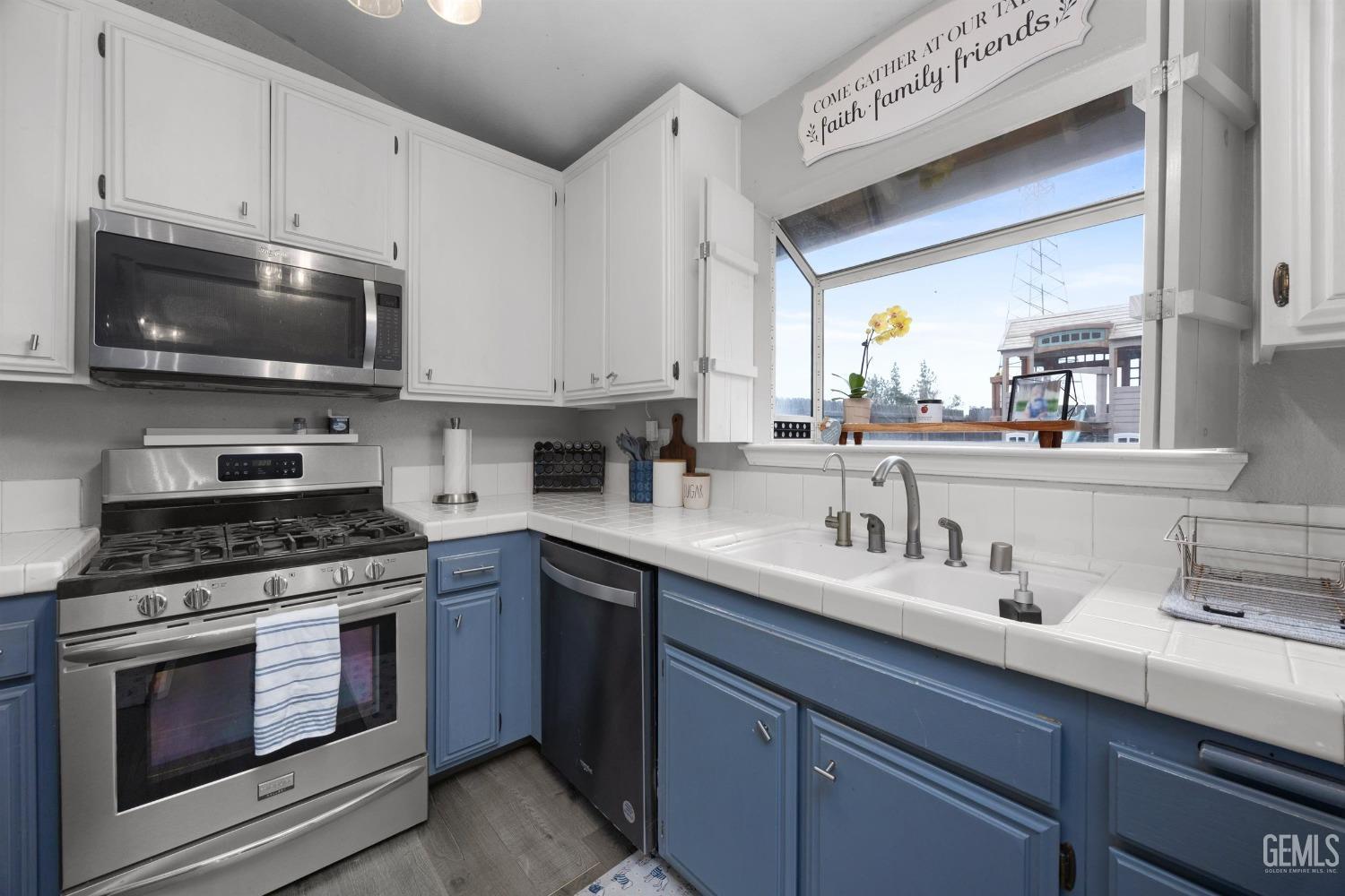 Undisclosed Address Bakersfield, CA 93312 - Photo 14 of 31 a kitchen with stainless steel appliances granite countertop a sink a stove and cabinets