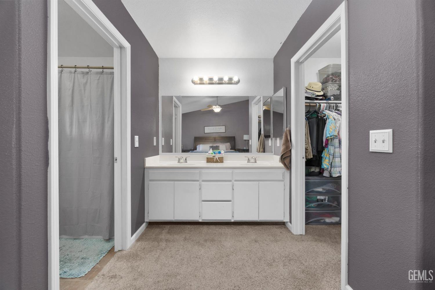 Undisclosed Address Bakersfield, CA 93312 - Photo 19 of 31 a bathroom with a sink vanity and mirror