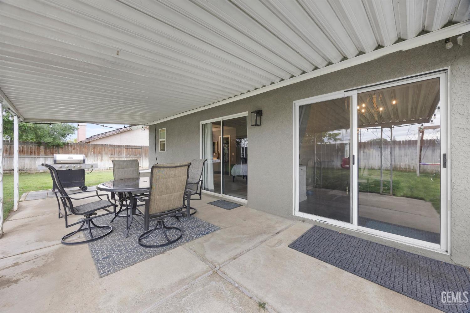 Undisclosed Address Bakersfield, CA 93312 - Photo 24 of 31 a view of a patio with table and chairs and potted plants