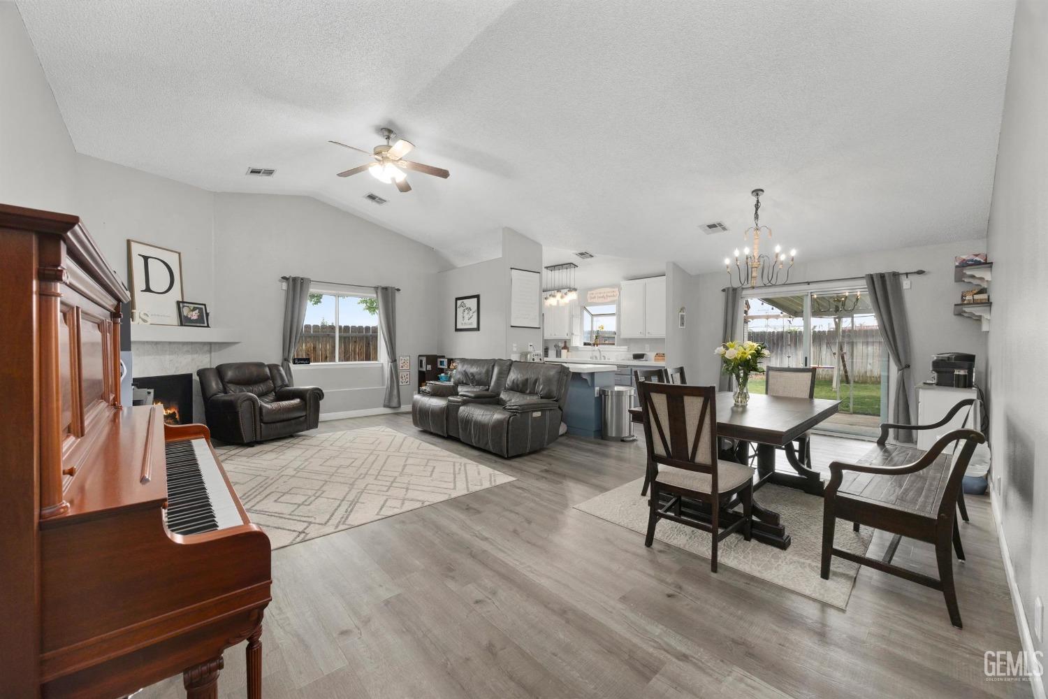 Undisclosed Address Bakersfield, CA 93312 - Photo 5 of 31 a living room with furniture kitchen view and a chandelier