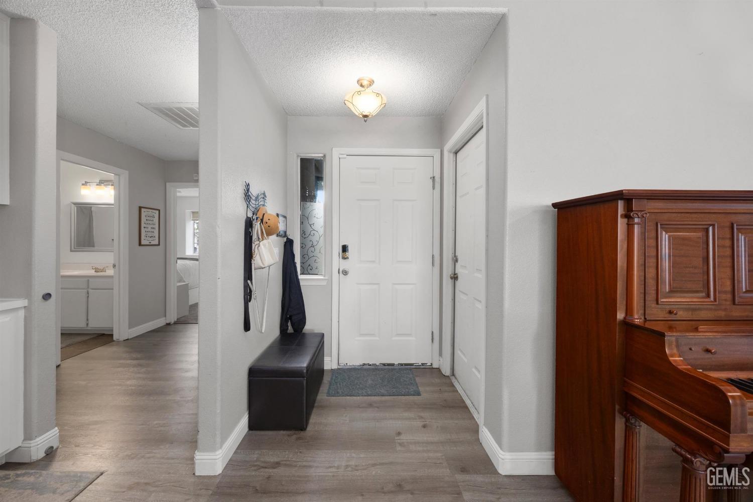 Undisclosed Address Bakersfield, CA 93312 - Photo 6 of 31 a view of a hallway with closet and a fireplace