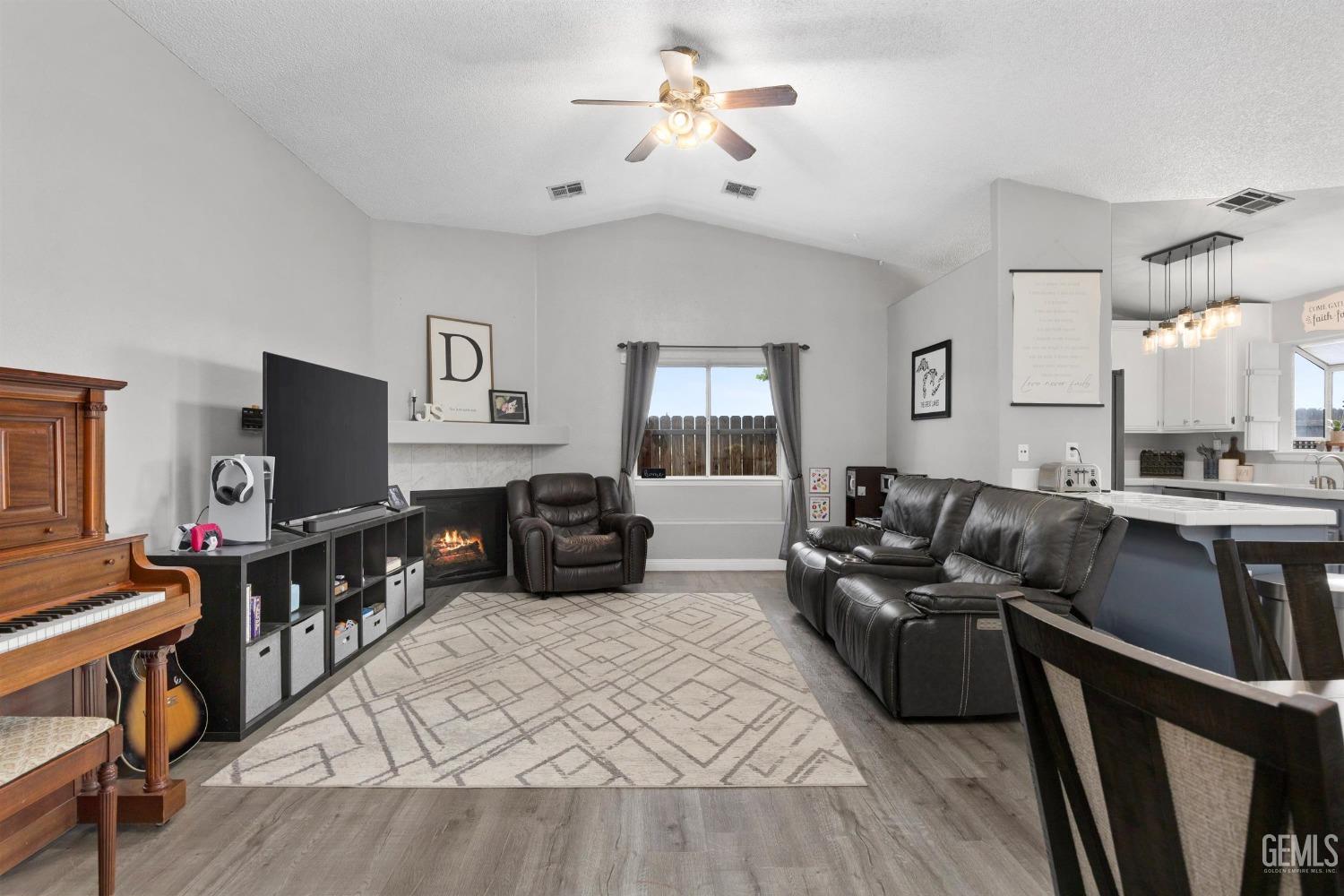 Undisclosed Address Bakersfield, CA 93312 - Photo 7 of 31 a living room with furniture and a flat screen tv