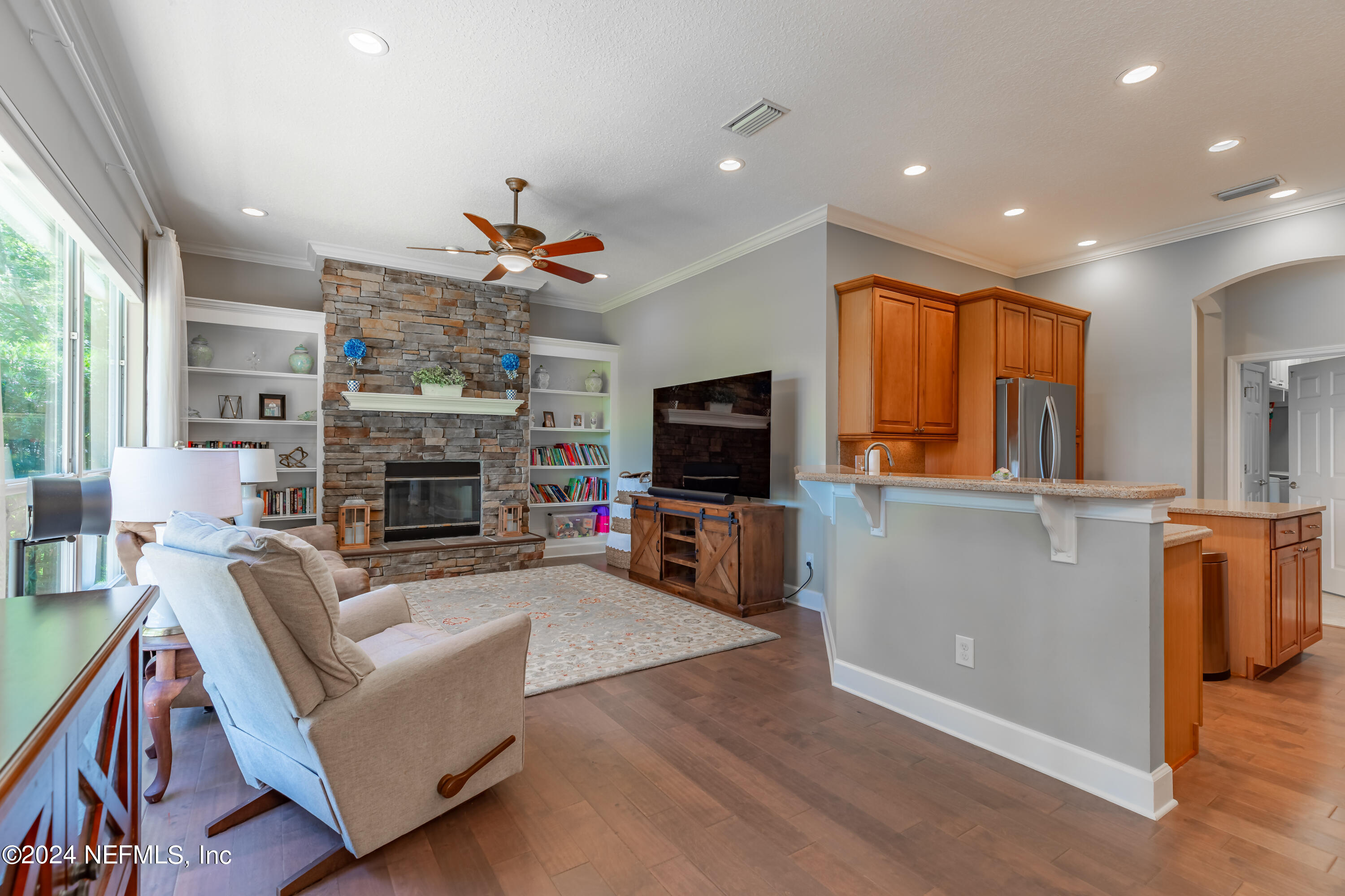 2032 Rivergate Drive Fleming Island, FL 32003 - Photo 11 of 120 a living room with fireplace furniture and a flat screen tv