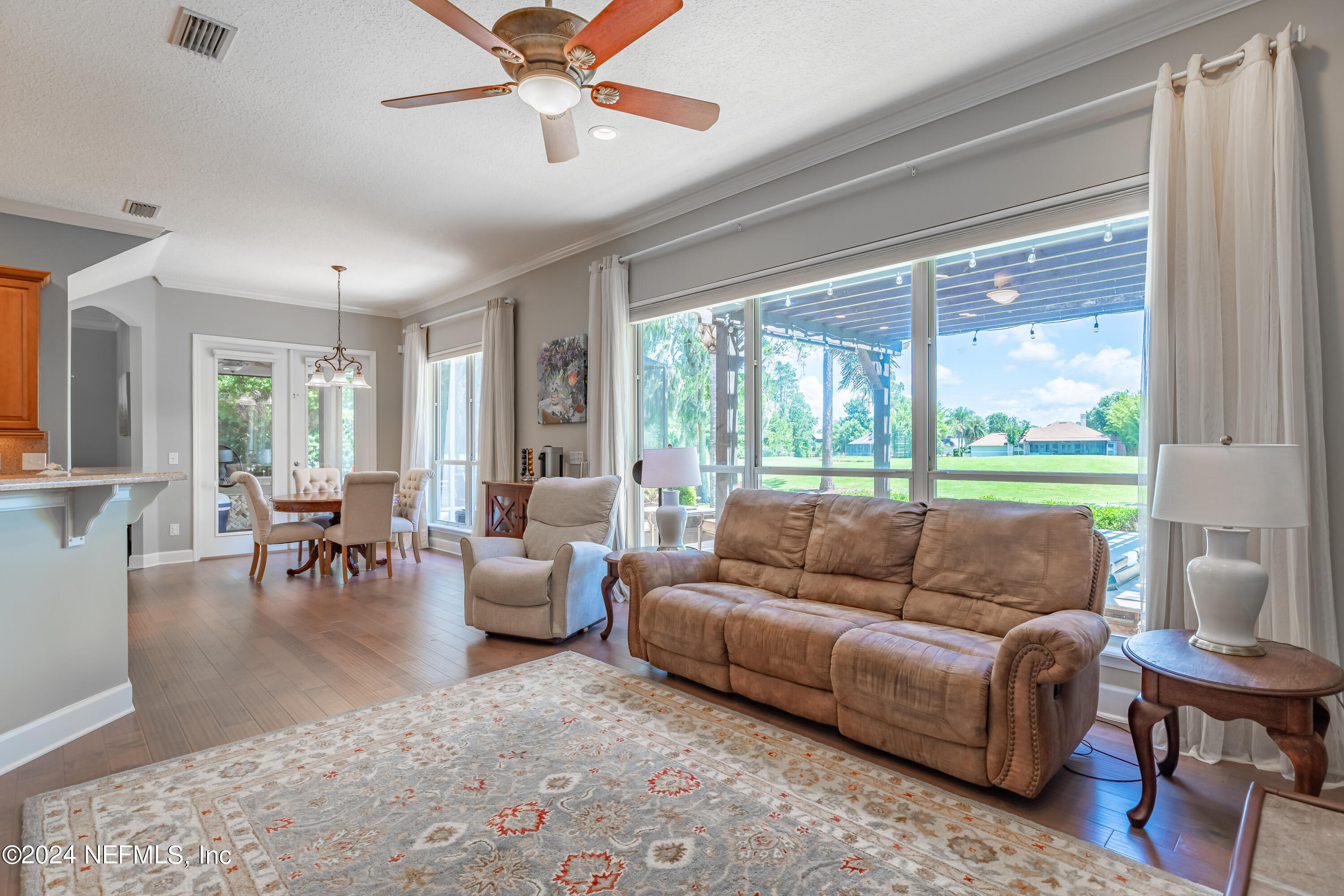 2032 Rivergate Drive Fleming Island, FL 32003 - Photo 12 of 120 a living room with furniture and a large window