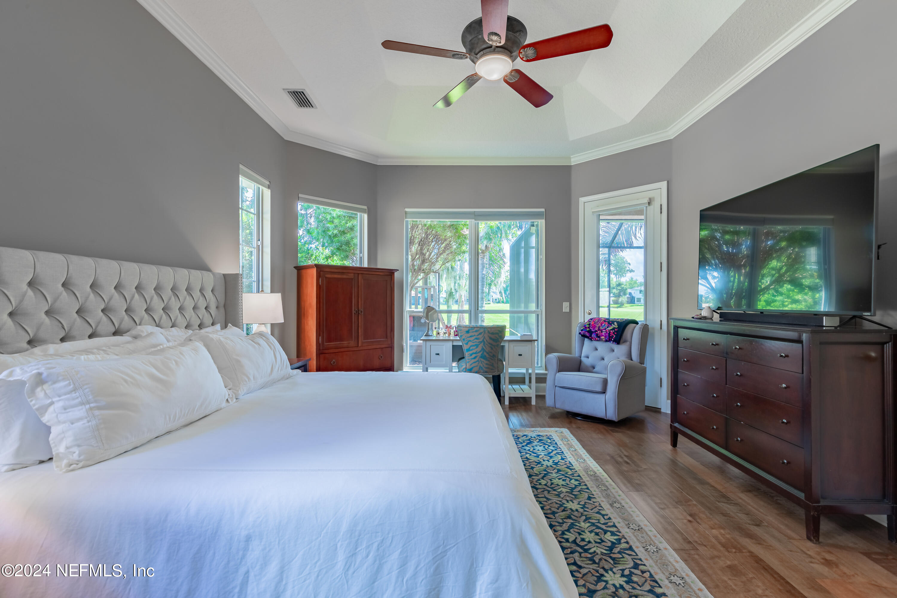 2032 Rivergate Drive Fleming Island, FL 32003 - Photo 15 of 120 a bedroom with a balcony a bed and wooden floor