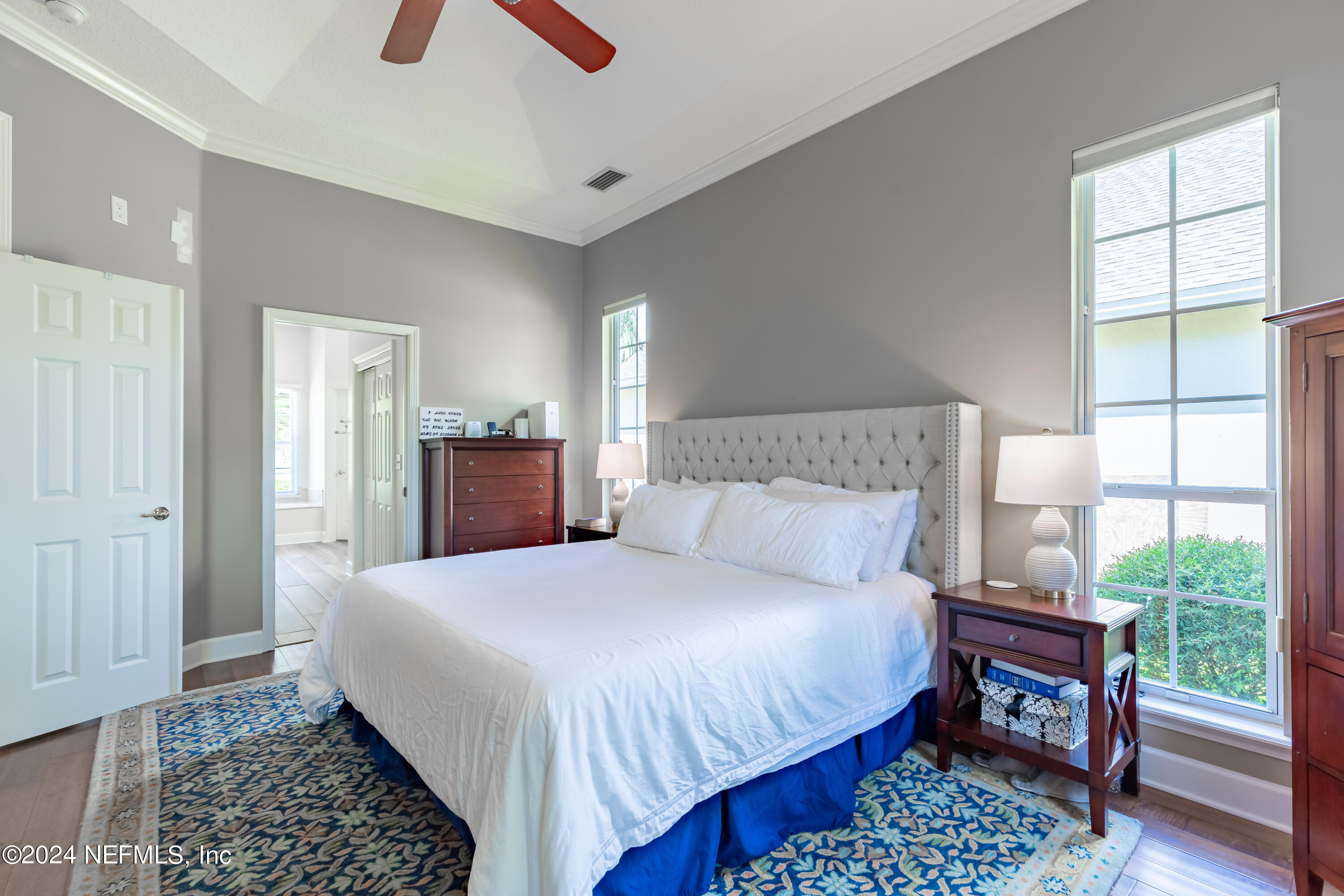 2032 Rivergate Drive Fleming Island, FL 32003 - Photo 18 of 120 a bedroom with a bed and wooden floor