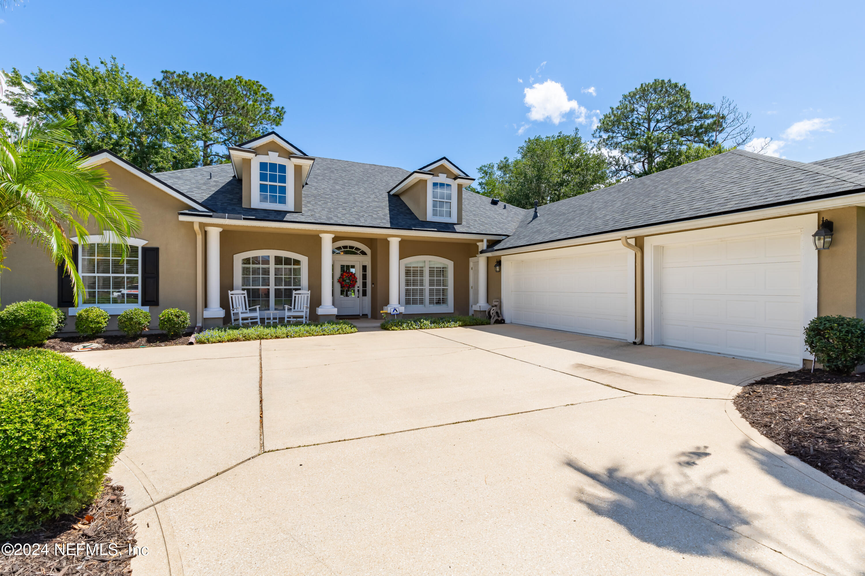 2032 Rivergate Drive Fleming Island, FL 32003 - Photo 2 of 120 a front view of a house with a yard and garage