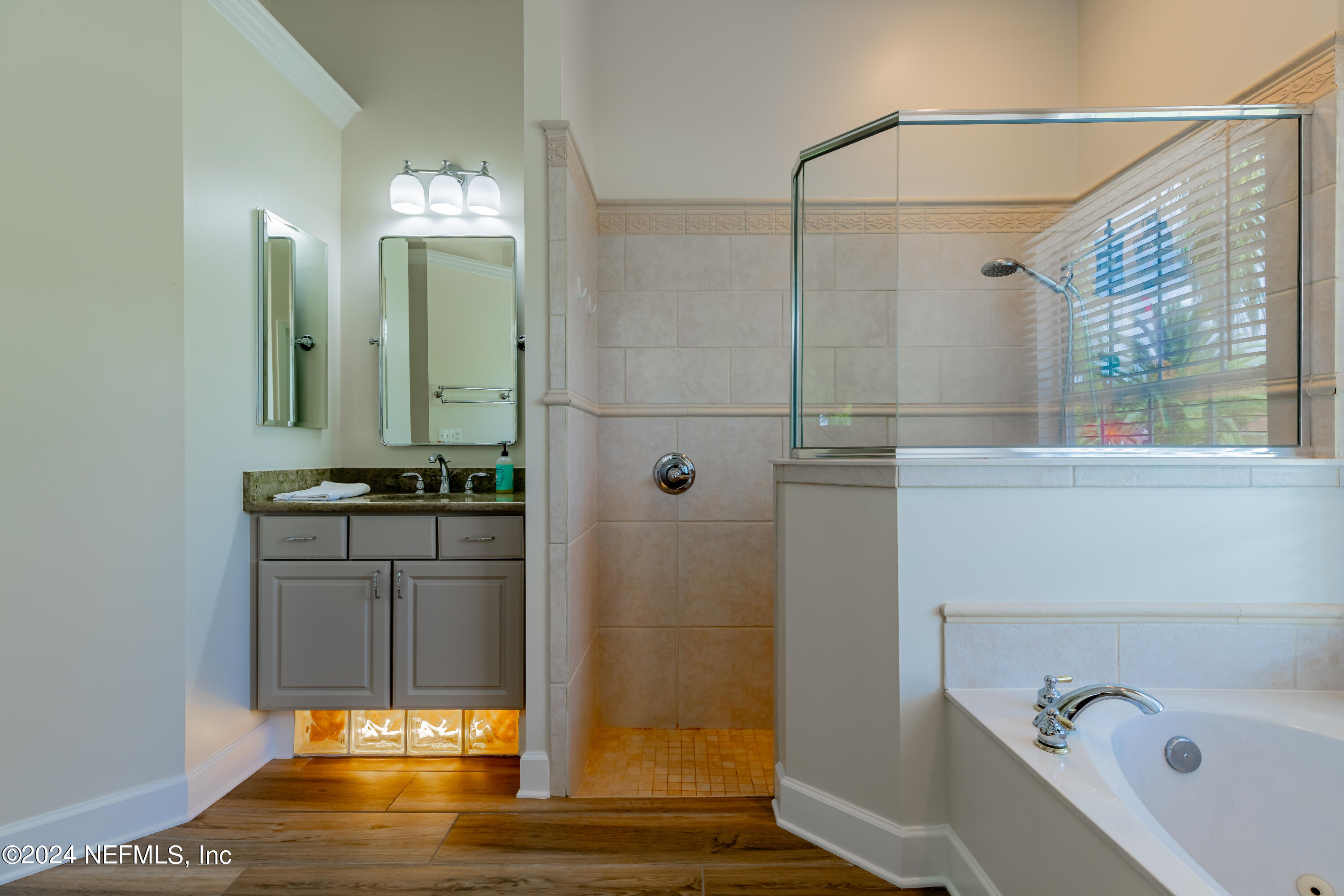 2032 Rivergate Drive Fleming Island, FL 32003 - Photo 21 of 120 a bathroom with a tub and a shower