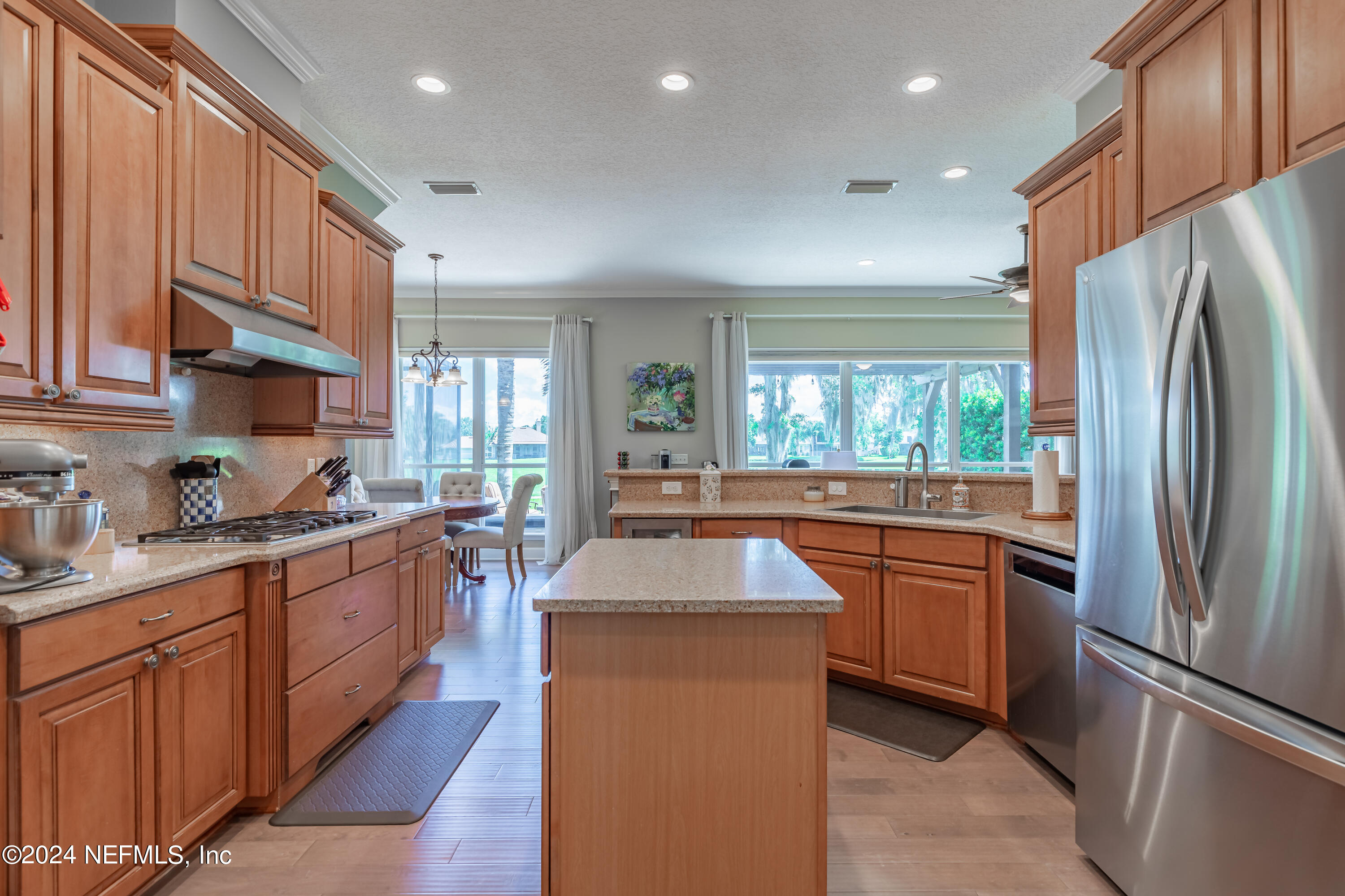 2032 Rivergate Drive Fleming Island, FL 32003 - Photo 24 of 120 a kitchen with stainless steel appliances granite countertop a refrigerator a sink dishwasher a stove with large countertops and cabinets
