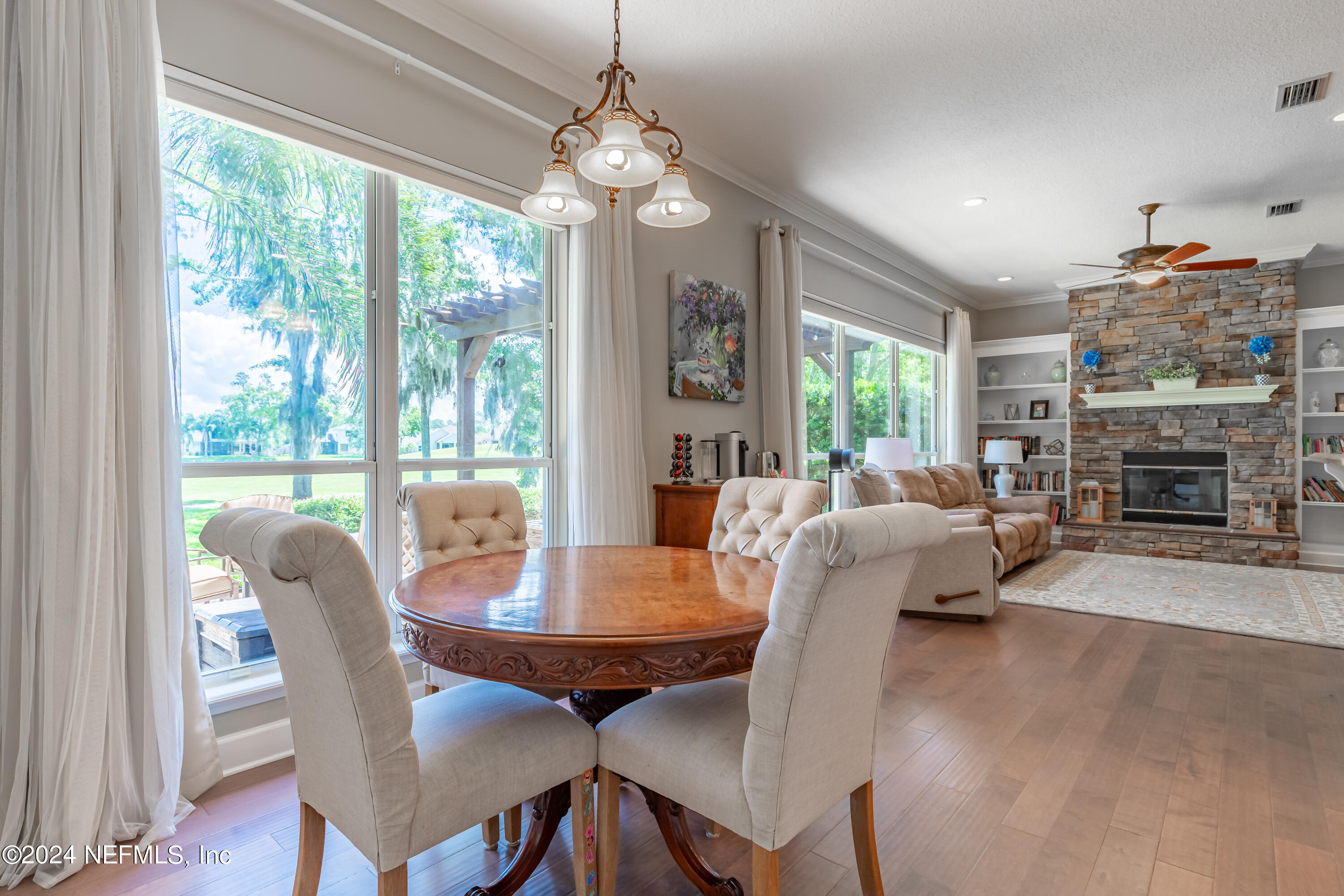 2032 Rivergate Drive Fleming Island, FL 32003 - Photo 30 of 120 a view of a dining room with furniture window and wooden floor