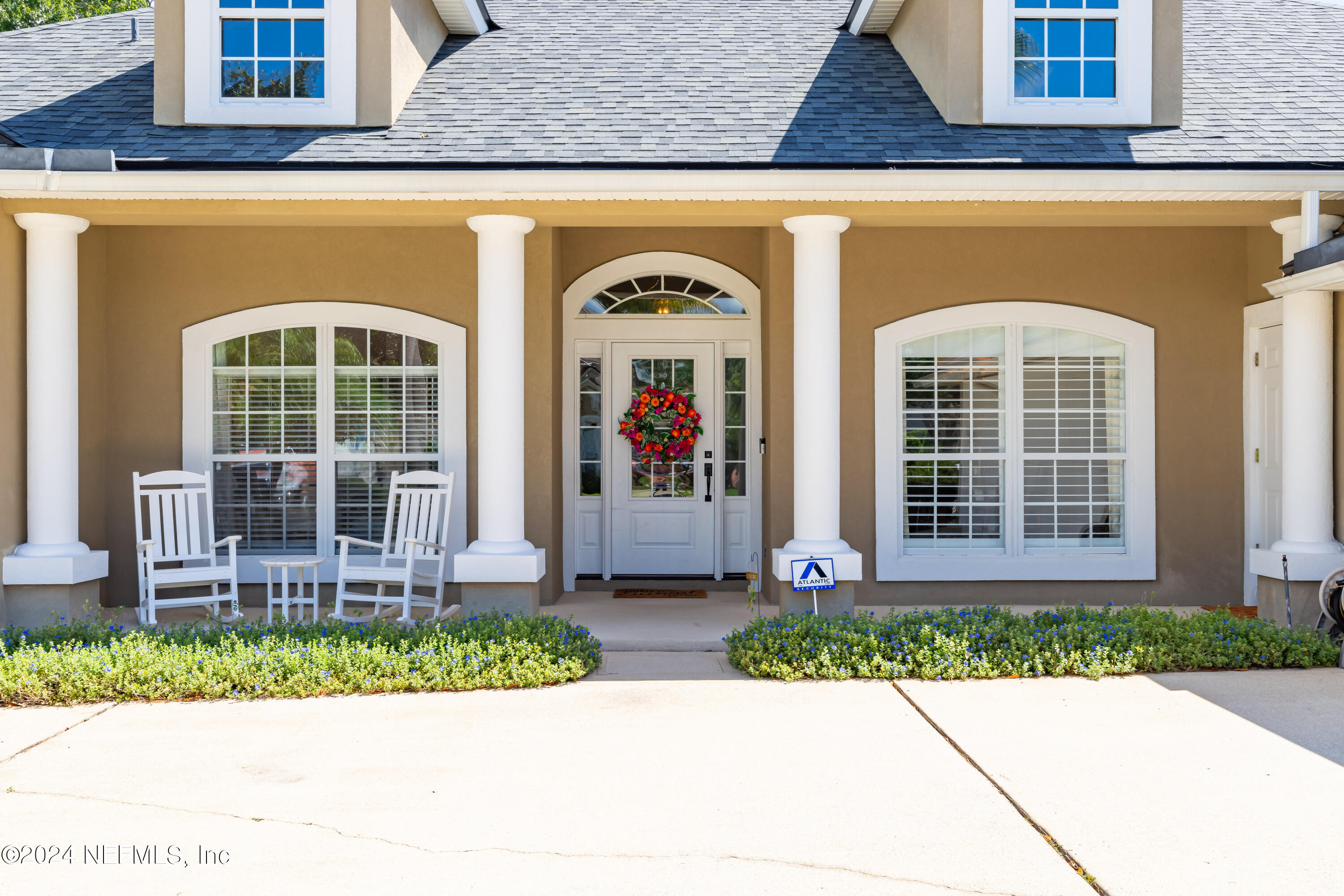 2032 Rivergate Drive Fleming Island, FL 32003 - Photo 4 of 120 a front view of a house with a yard and potted plants