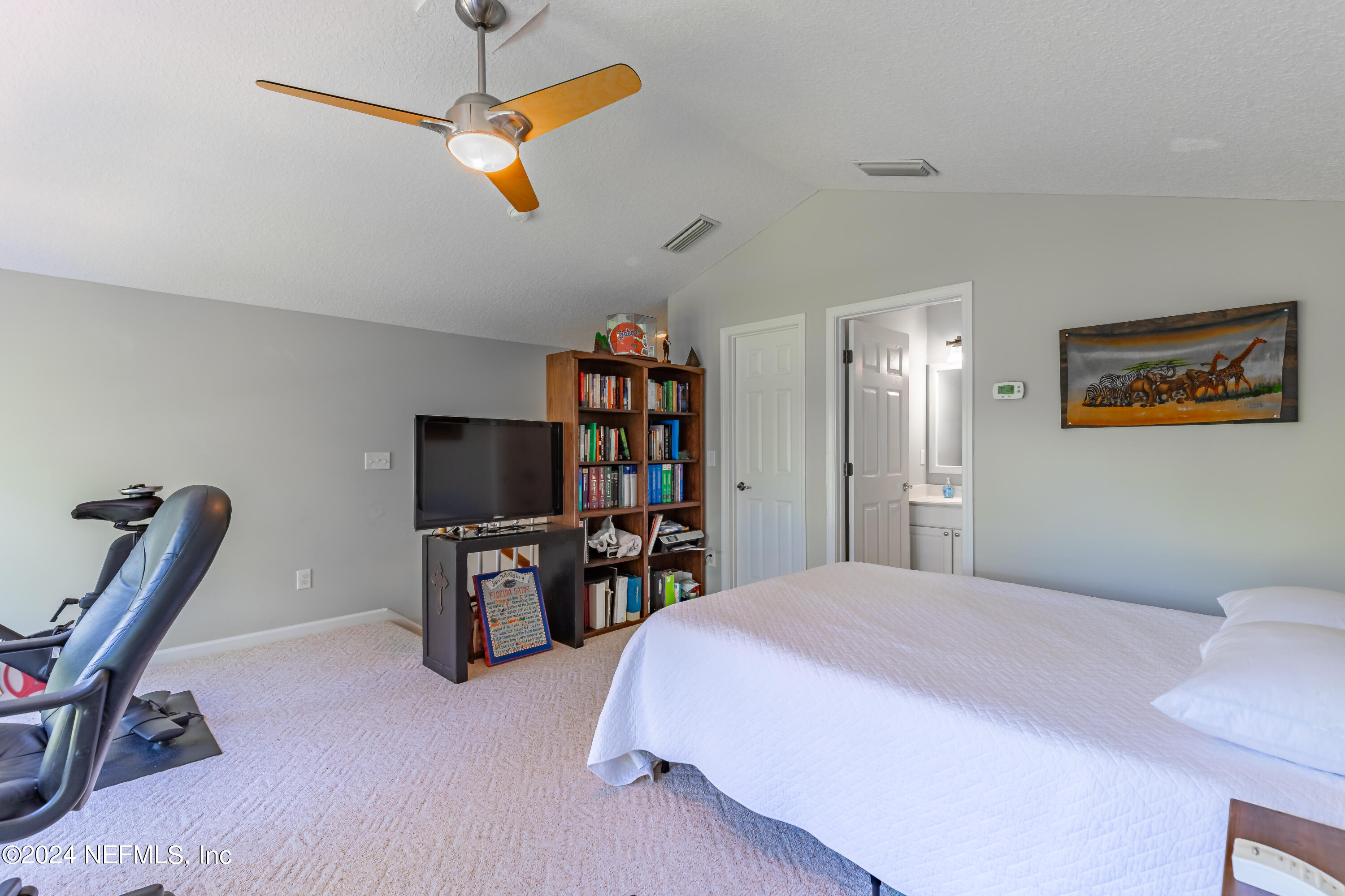 2032 Rivergate Drive Fleming Island, FL 32003 - Photo 41 of 120 a bedroom with a bed a desk and chair