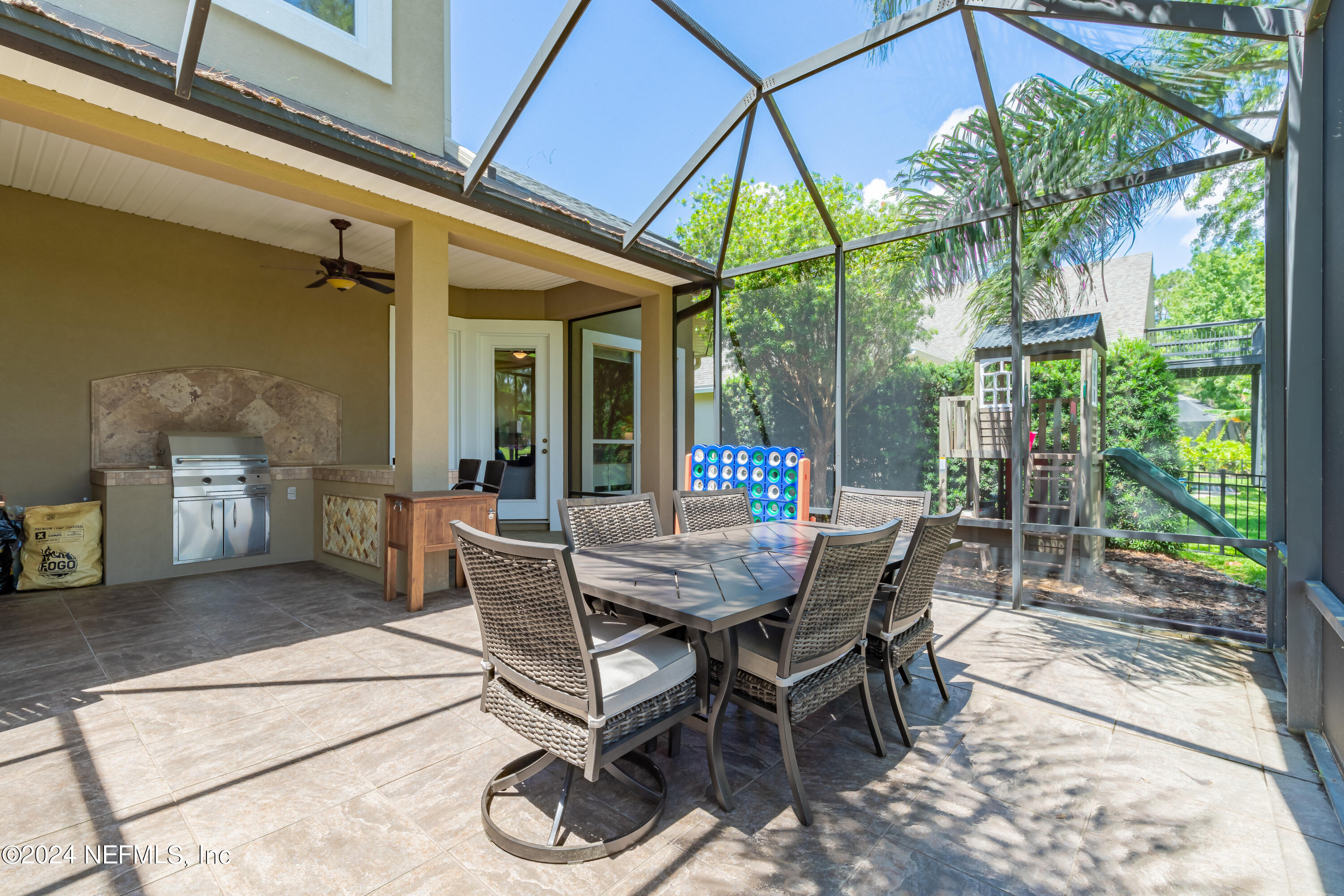 2032 Rivergate Drive Fleming Island, FL 32003 - Photo 44 of 120 a view of a patio with a table and chairs under an umbrella