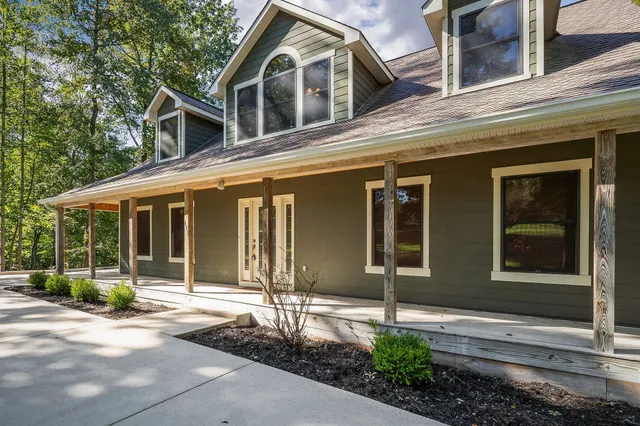 a backyard of a house with wooden floor and fence