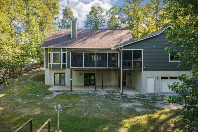 a kitchen with stainless steel appliances granite countertop a refrigerator a sink dishwasher a stove and white countertops with wooden floor