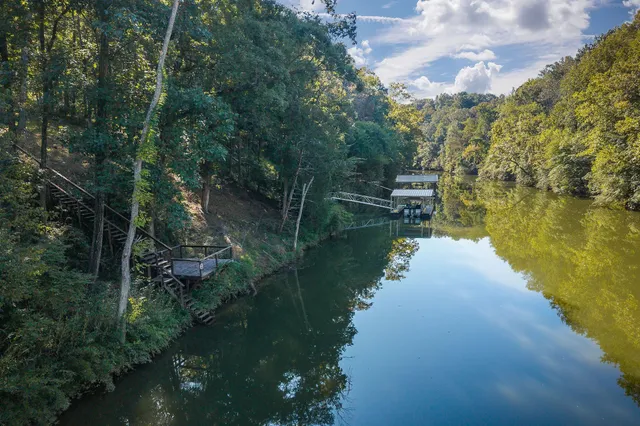 a bathroom with double vanity sink a vanity and a large mirror