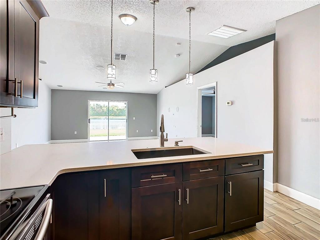 3194 Windmill Point Boulevard Kissimmee, FL 34746 - Photo 12 of 32 a kitchen with a sink and a stove
