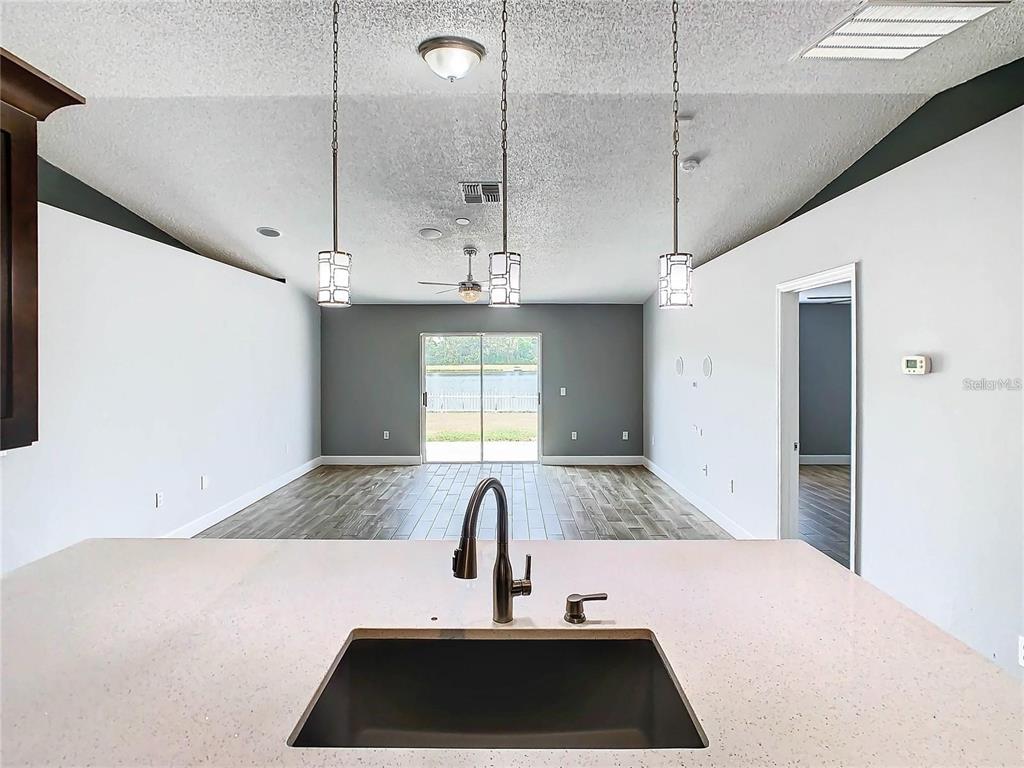 3194 Windmill Point Boulevard Kissimmee, FL 34746 - Photo 13 of 32 a kitchen with a sink and a refrigerator