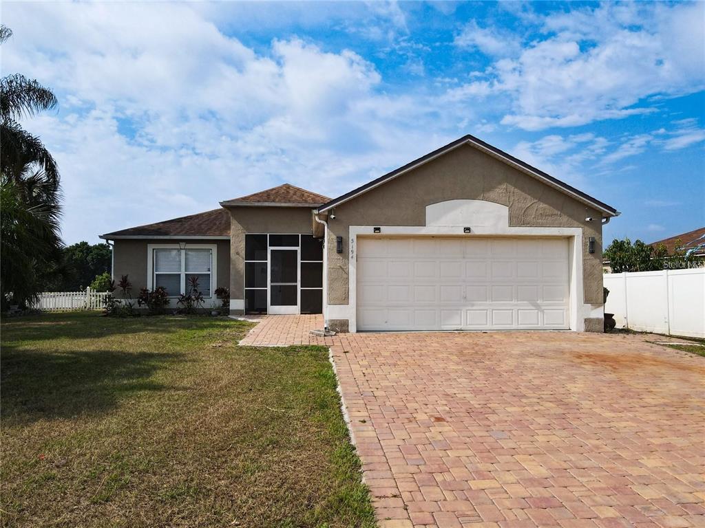 3194 Windmill Point Boulevard Kissimmee, FL 34746 - Photo 2 of 32 a front view of a house with a yard and garage