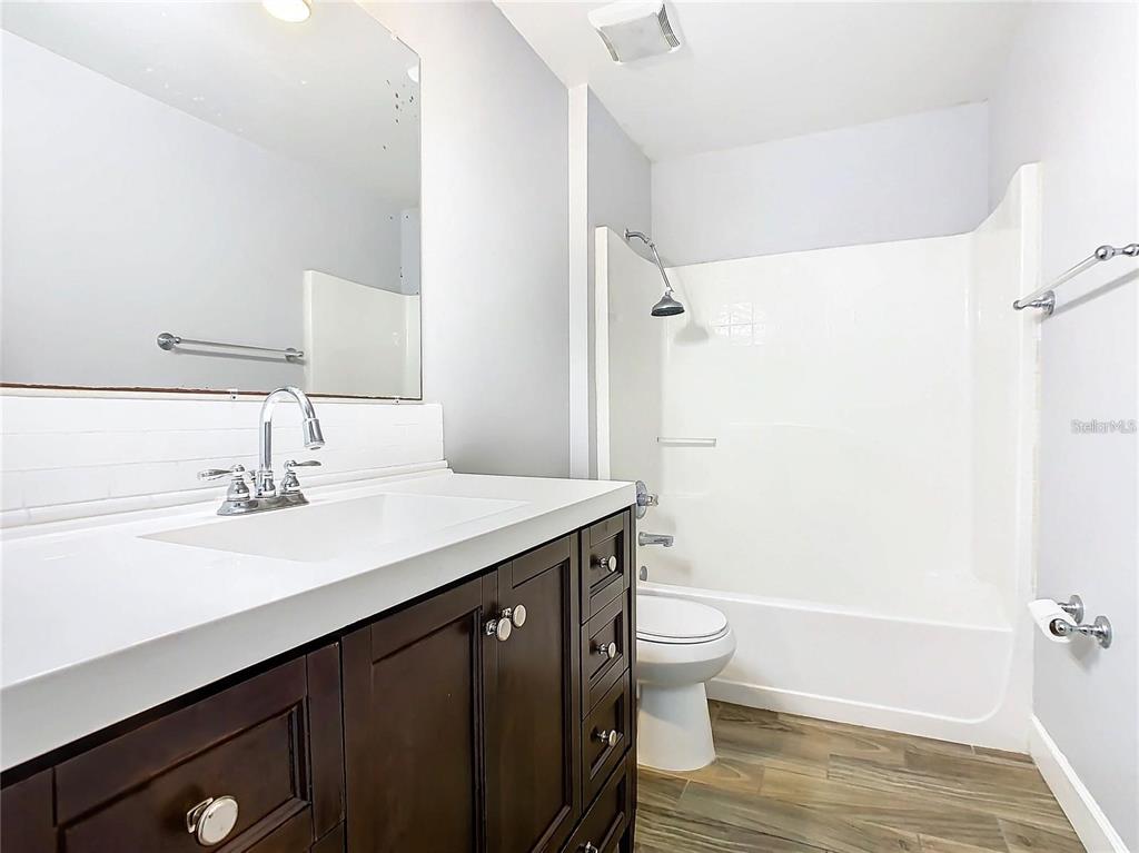 3194 Windmill Point Boulevard Kissimmee, FL 34746 - Photo 22 of 32 a bathroom with a sink a toilet and shower