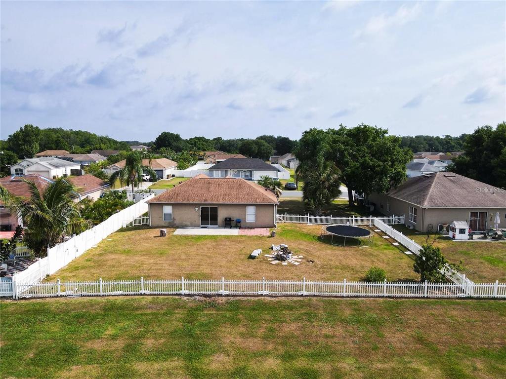 3194 Windmill Point Boulevard Kissimmee, FL 34746 - Photo 28 of 32 a view of a house with swimming pool and mountains in the background