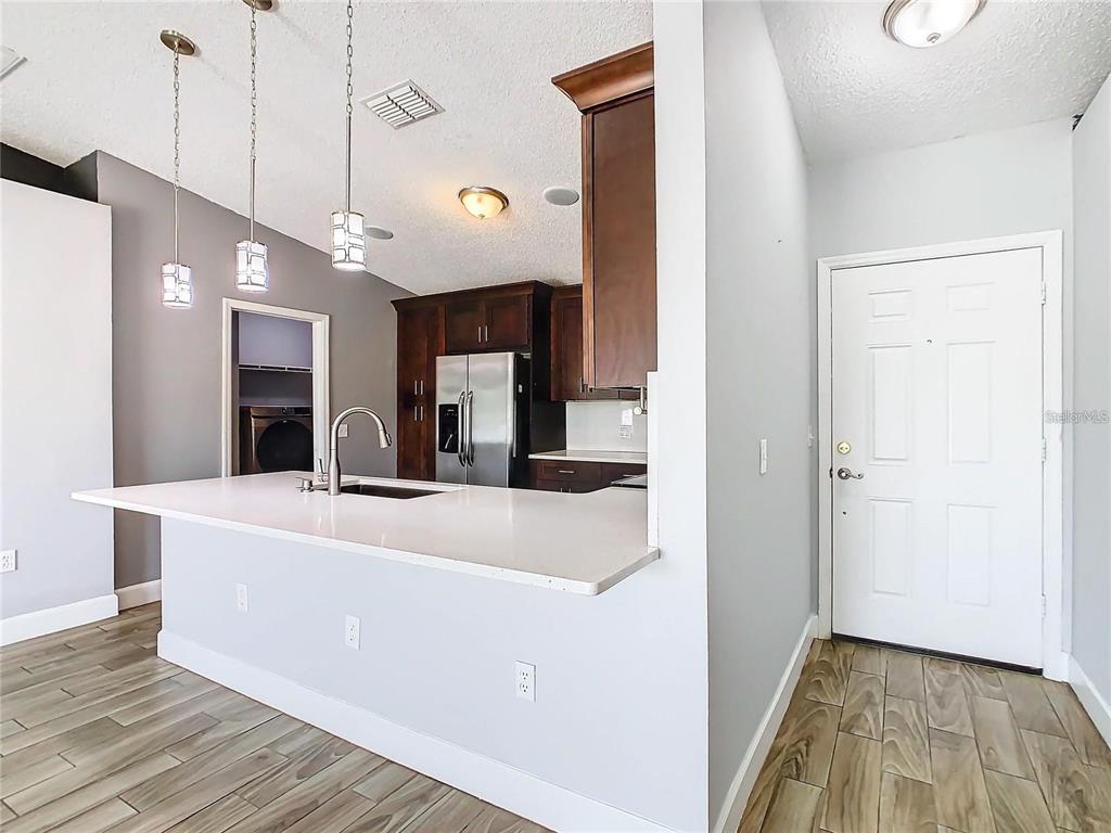 3194 Windmill Point Boulevard Kissimmee, FL 34746 - Photo 3 of 32 a view of a kitchen and a chandelier