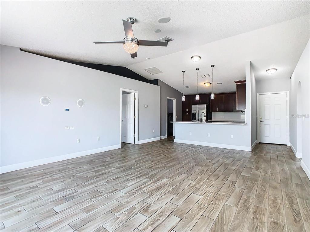3194 Windmill Point Boulevard Kissimmee, FL 34746 - Photo 4 of 32 a view of an empty room with wooden floor