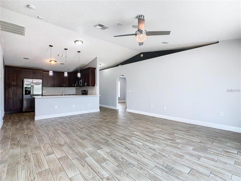 3194 Windmill Point Boulevard Kissimmee, FL 34746 - Photo 5 of 32 a view of a kitchen with a sink and a refrigerator