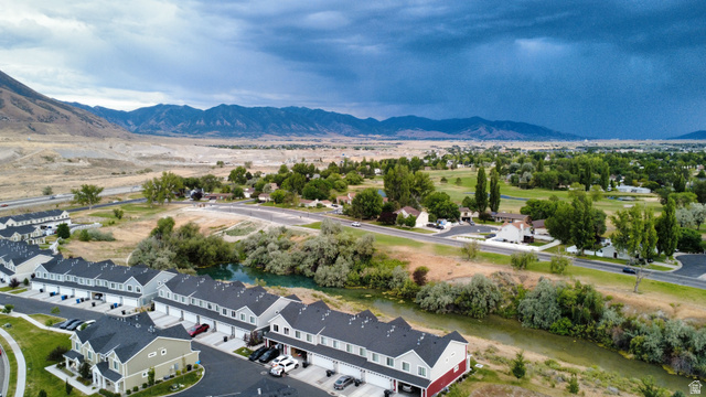 562 Hal Street, Unit 152 Tooele, UT 84074 - Photo 41 of 44 Development featuring multiple townhomes with asphalt driveways, two-car garages, and dark shingle roofs
