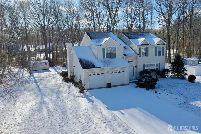 a view of a house with a yard covered in snow