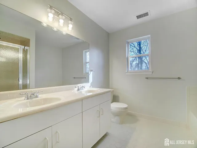 a bathroom with a double vanity sink and a mirror