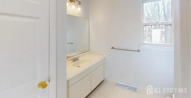 a bathroom with a sink and vanity
