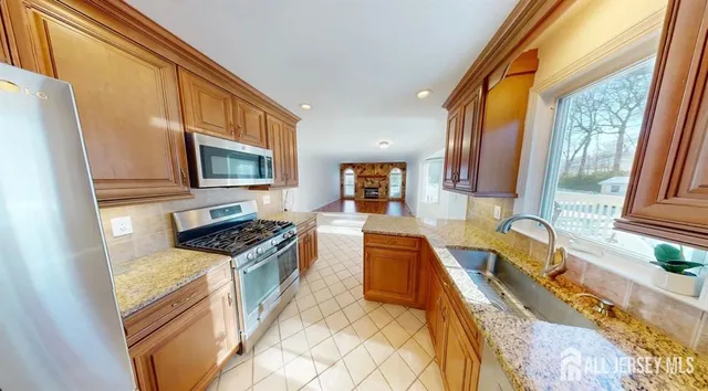 a kitchen with granite countertop a sink and a stove top oven