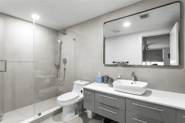 a bathroom with a sink toilet and shower