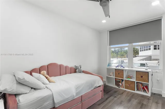 a bedroom with a bed and a large window