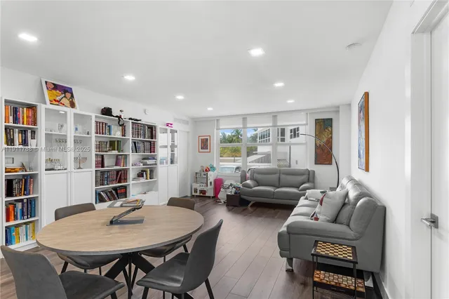 a living room with furniture and a book shelf