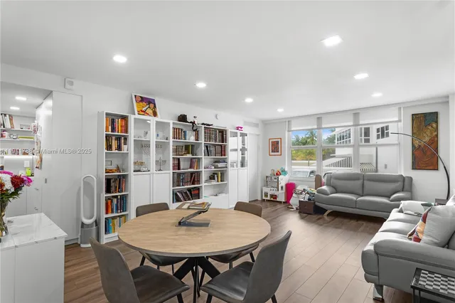 a living room with furniture and a book shelf