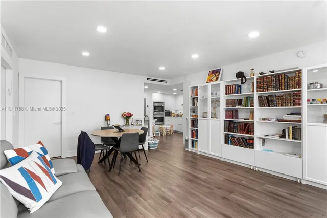a dining room with furniture and wooden floor