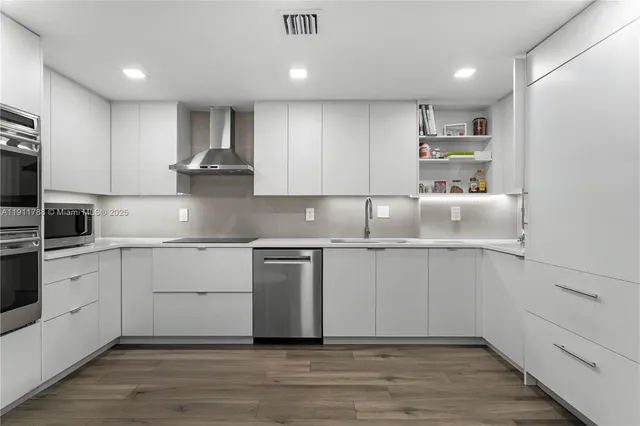 a kitchen with granite countertop cabinets and wooden floor