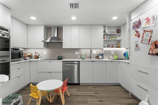 a kitchen with a sink cabinets and wooden floor