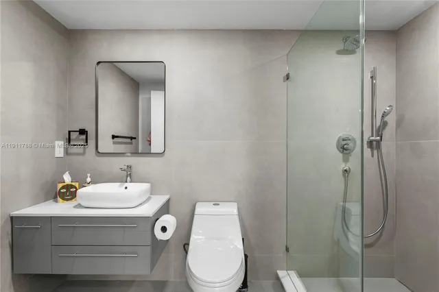 a bathroom with a sink toilet and shower