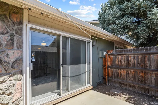a view of a house with a deck and a yard
