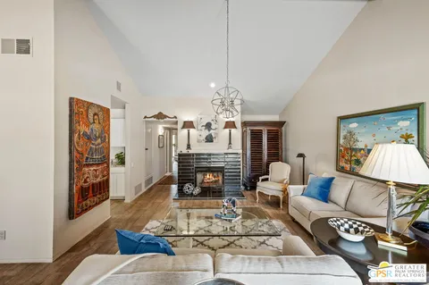 a living room with furniture a dining table and a fireplace