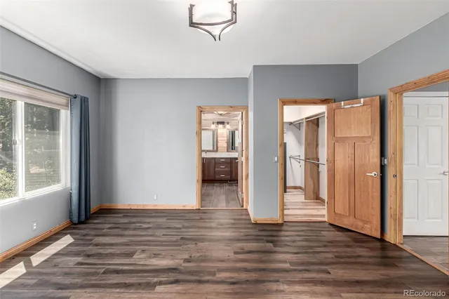 a view of a room with wooden floor and a window