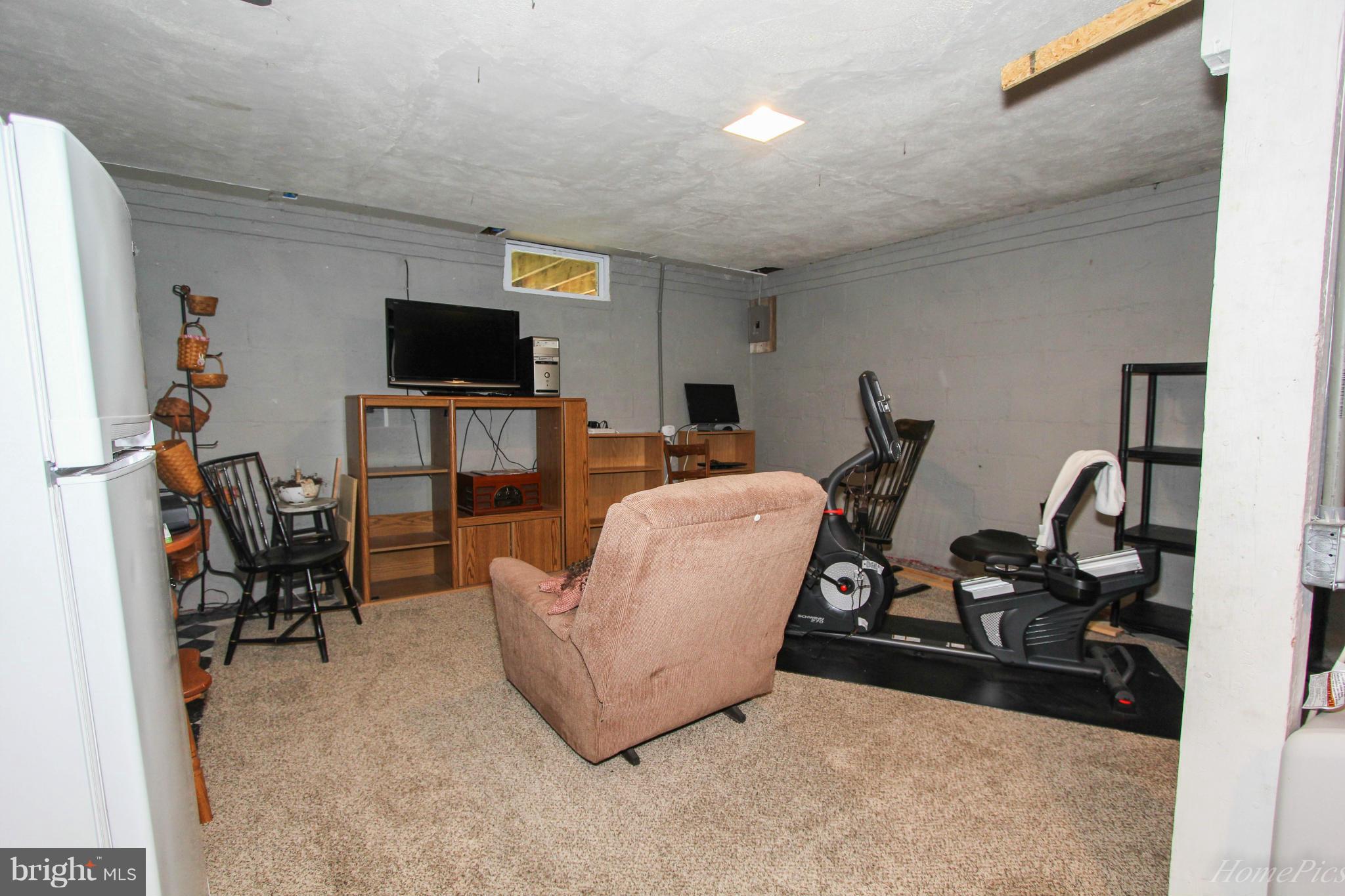 340 Devonshire Road Hagerstown, MD 21740 - Photo 20 of 26 a room with furniture a flat screen tv and a window