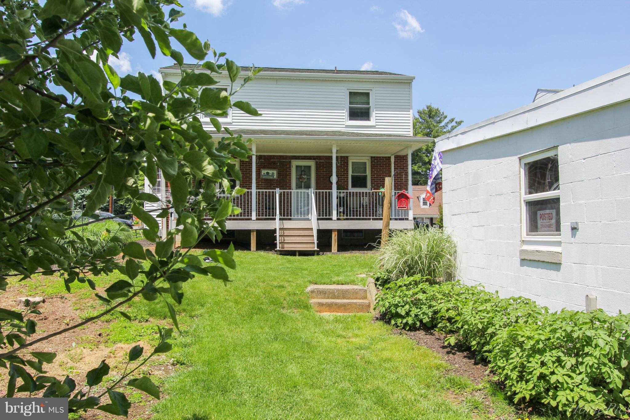 340 Devonshire Road Hagerstown, MD 21740 - Photo 24 of 26 a view of a house with potted plants and a table and chair