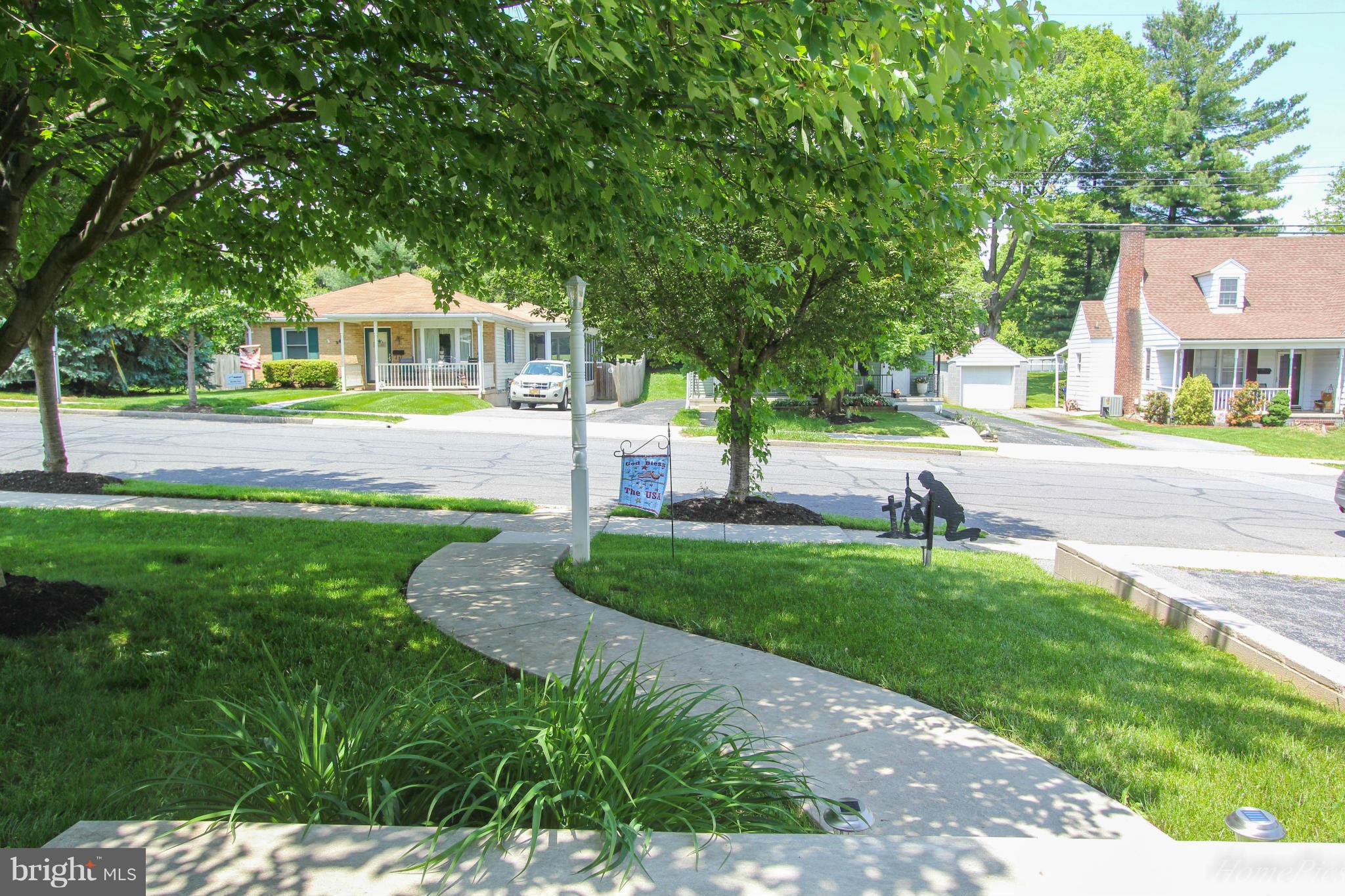 340 Devonshire Road Hagerstown, MD 21740 - Photo 26 of 26 a front view of a house with a garden and trees