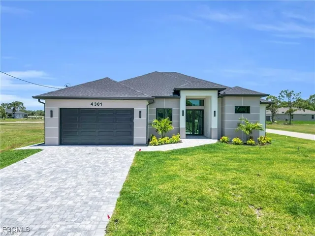 a front view of a house with a yard and porch