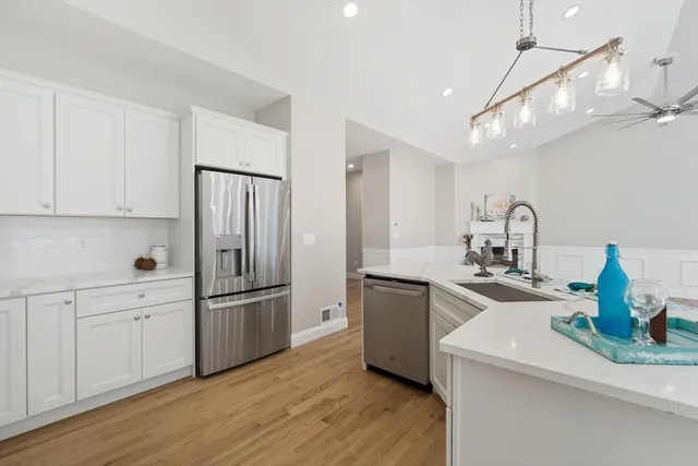 a kitchen with refrigerator and cabinets