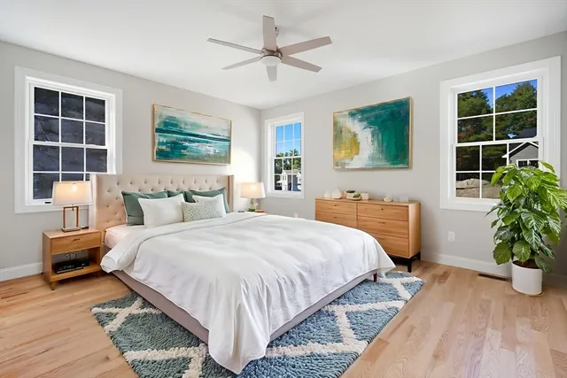 a bedroom with bed and a potted plant